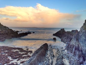 Scenic view of sea against cloudy sky