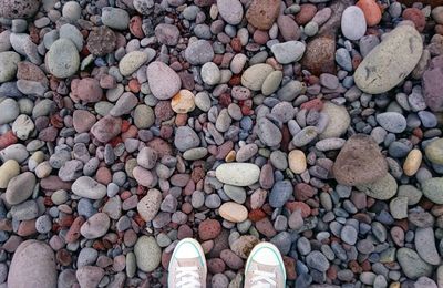 Low section of person standing on tiled floor