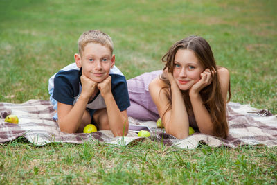 Portrait of teenage girl lying on grass