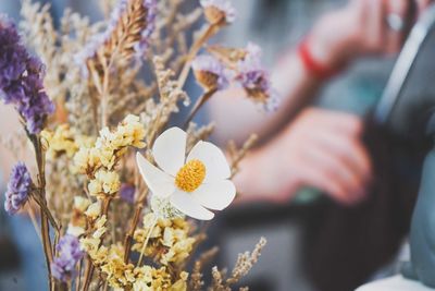 Midsection of woman holding flower