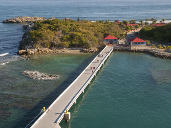 High angle view of town by calm blue sea