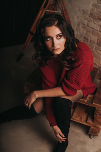 Portrait of beautiful woman sitting on floor