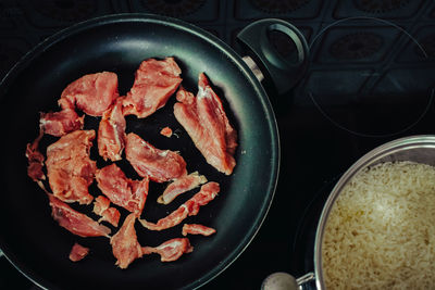 High angle view of meat in cooking pan