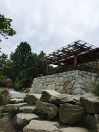 Stone wall against cloudy sky