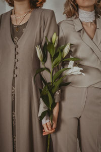 Midsection of women holding plants