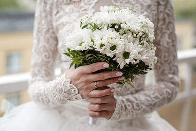 Close-up of hand holding white flower plant