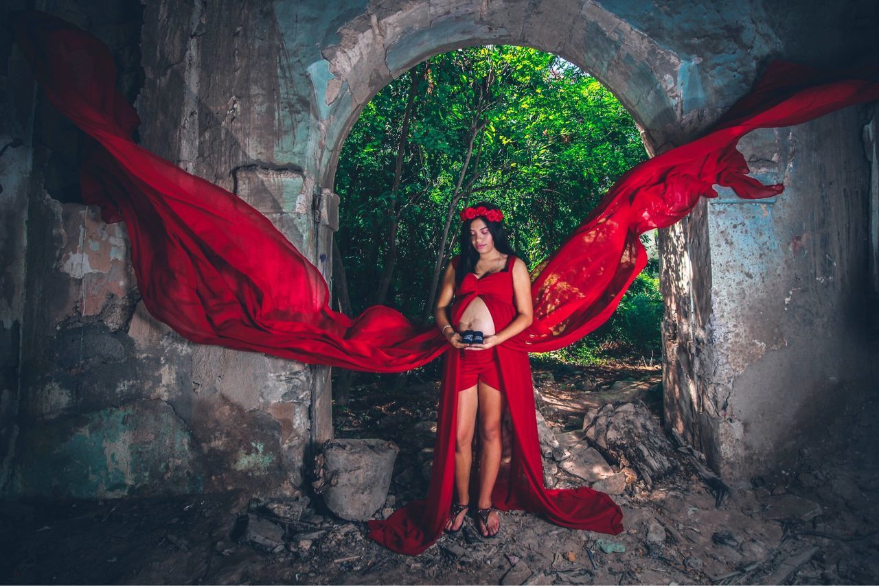 FULL LENGTH OF WOMAN STANDING BY RED UMBRELLA