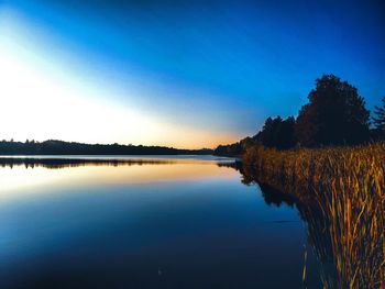Scenic view of lake against blue sky