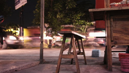 Chairs and tables on street against buildings in city