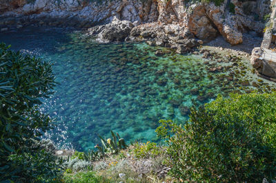 High angle view of rocks by sea