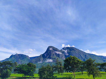 Scenic view of mountains against blue sky