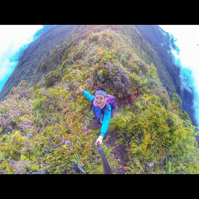 lifestyles, leisure activity, full length, mountain, transfer print, casual clothing, auto post production filter, standing, tree, adventure, men, holding, sky, young adult, rear view, low angle view, green color, day