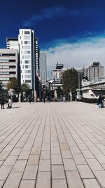 Street amidst buildings in city against sky