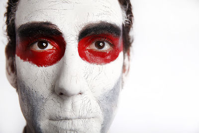 Man with white mascara and bloody in front of a white background