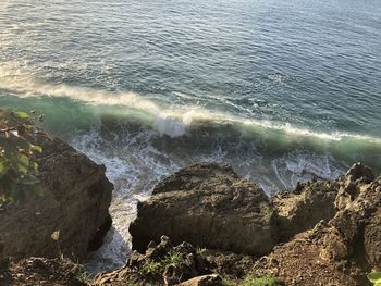 High angle view of rocks at sea shore