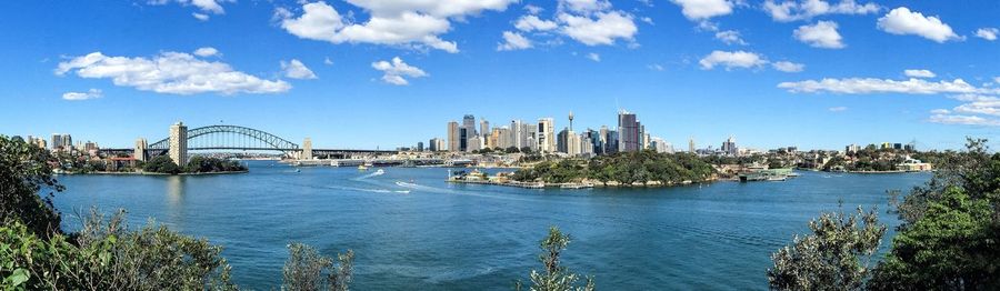 City by river against sky