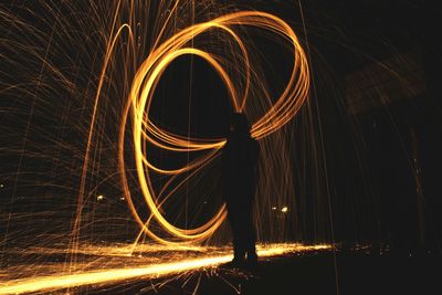 Silhouette person with light painting at night