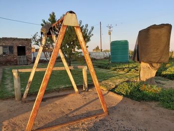 Old wooden house on field against sky