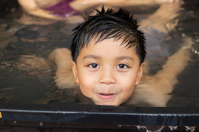 Portrait of cute boy in swimming pool