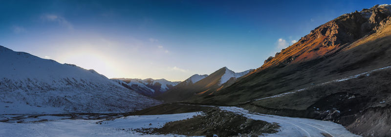 Panoramic view of snowcapped mountains against sky during sunset