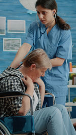 Side view of mother and daughter at beach
