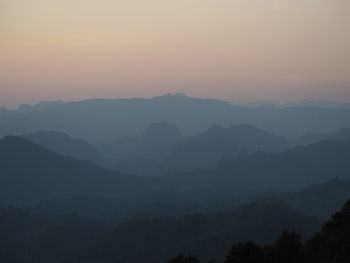 Scenic view of silhouette mountains against sky at sunset