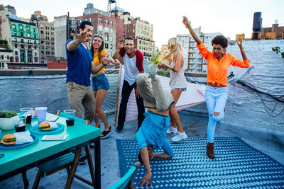 Rear view of people enjoying in water