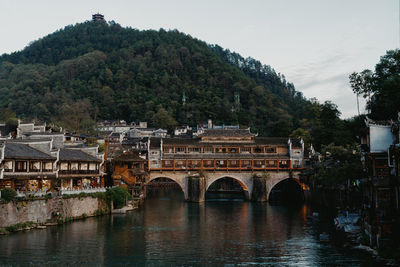 Bridge over river against mountain