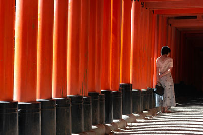 Rear view of man standing at temple outside building