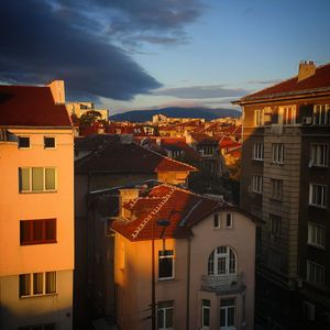 Residential buildings in city against sky