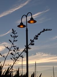 Low angle view of street light against sky at sunset