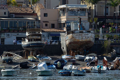 Boats moored at harbor in city