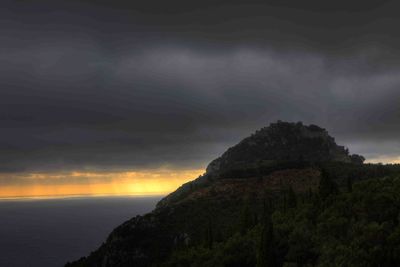 Scenic view of mountains against sky at sunset