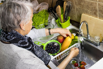 Midsection of woman having food at home