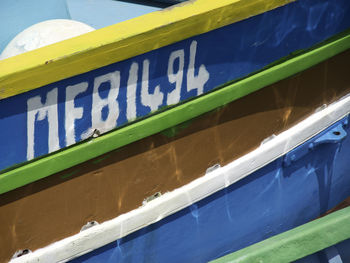 Low angle view of information sign against blue sky