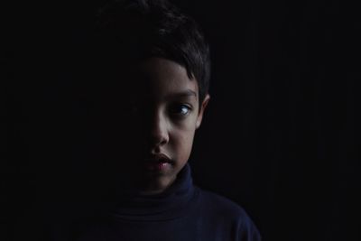 Portrait of teenage girl in darkroom