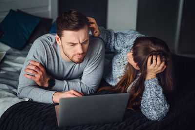 Young man using mobile phone at home