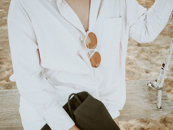  woman in a white shirt sitting on a swing