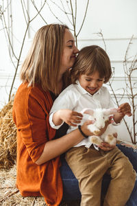 Easter kids playing with rabbits and ducks