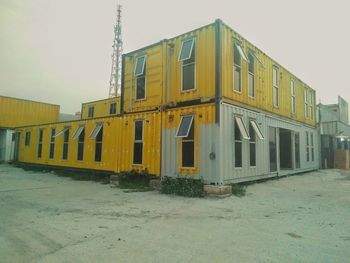 Exterior of yellow buildings against clear sky