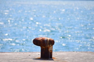 Close-up of rusty pier over sea