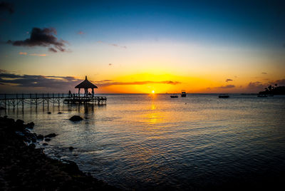 Silhouette of pier at sunset