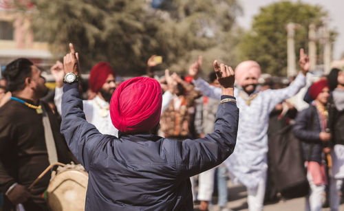 Rear view of people standing on street