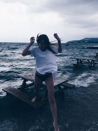 Full length of man standing on beach against sky