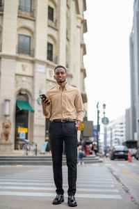 Full length of man standing on city street