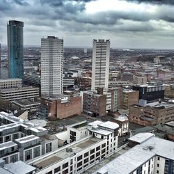 Cityscape against cloudy sky