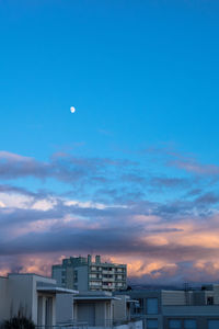 Low angle view of buildings against blue sky