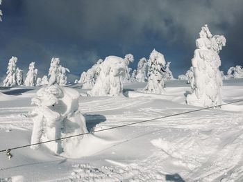 Snow covered land against sky