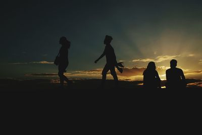 Silhouette people at sunset