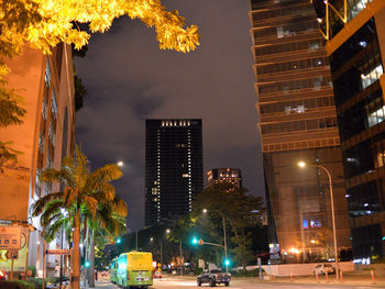 Low angle view of illuminated buildings against sky at night